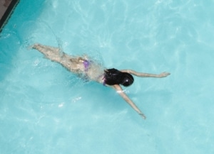 Person swimming in an indoor pool at Aquamotion leisure centre in Courchevel